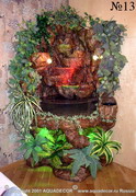Комнатный водопад на подставке в форме грота. Встроенное галогеновое освещение подсвечивает водяной поток и декоративные растения.